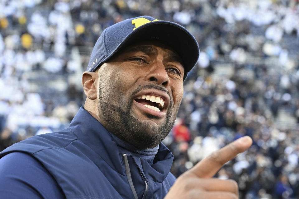 FILE - Michigan acting head coach Sherrone Moore celebrates a 24-15 win over Penn State following an NCAA college football game, Saturday, Nov. 11, 2023, in State College, Pa. With Moore and Notre Dame’s Marcus Freeman following similar paths, there is excitement that having Black faces in the most visible position at blue blood programs is becoming normalized and that young Black coaches finally are being viewed as the rising stars. (AP Photo/Barry Reeger, File)