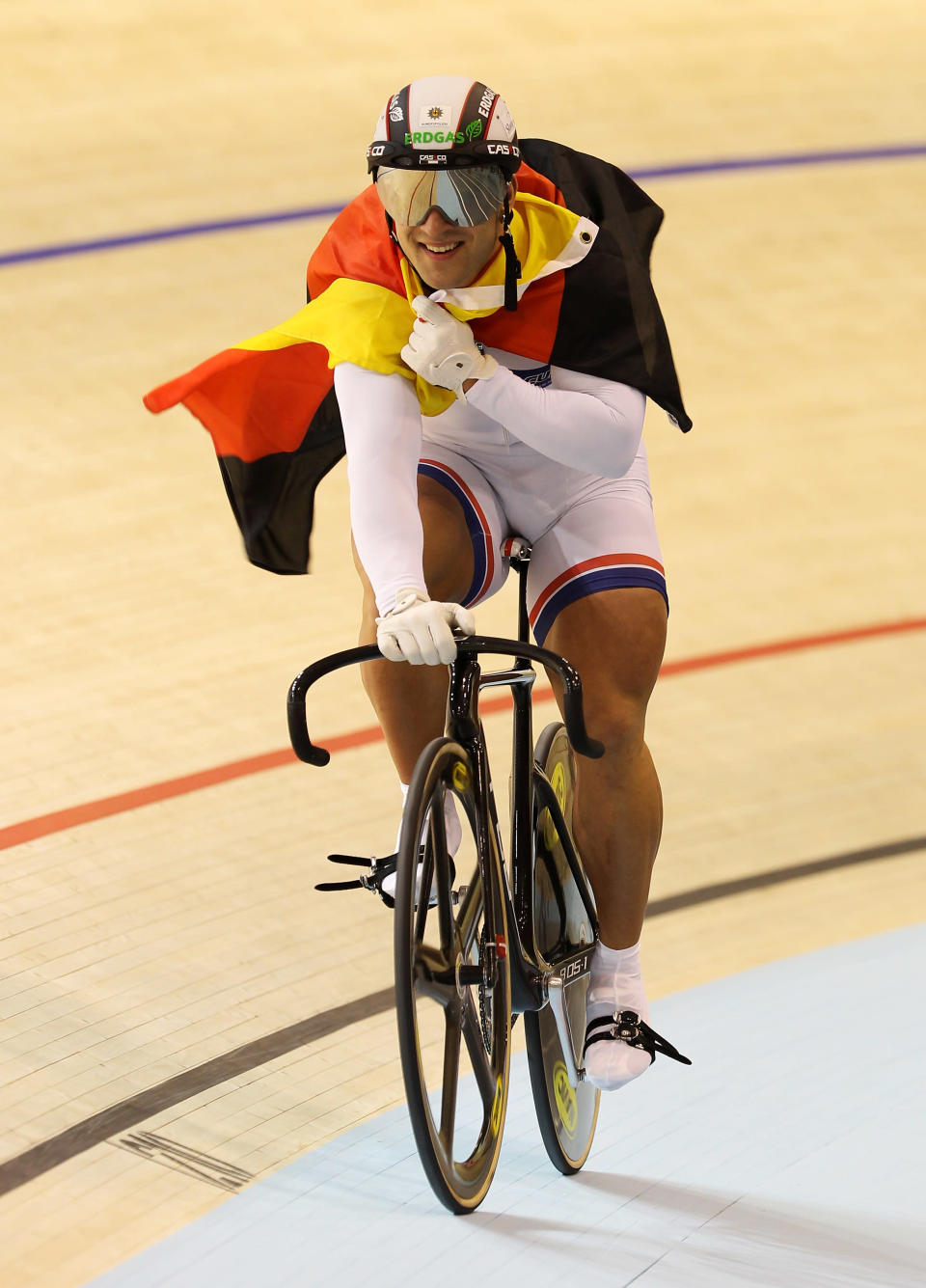 Robert Forstemann of Germany carries the Germany flag after winning Men's Team Sprint on Day One of the UCI Track Cycling World Championships at the Ballerup Super Arena on March 24, 2010 in Copenhagen, Denmark. (Getty Images)