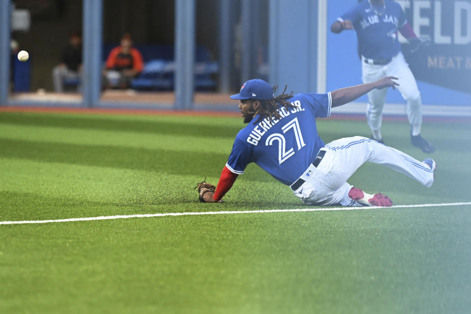 Toronto Blue Jays first baseman Vladimir Guerrero Jr. is unable to make a play on a pop double by Baltimore Orioles' Ryan McKenna during the first inning of a baseball game Monday, Aug. 15, 2022, in Toronto. (Jon Blacker/The Canadian Press via AP)