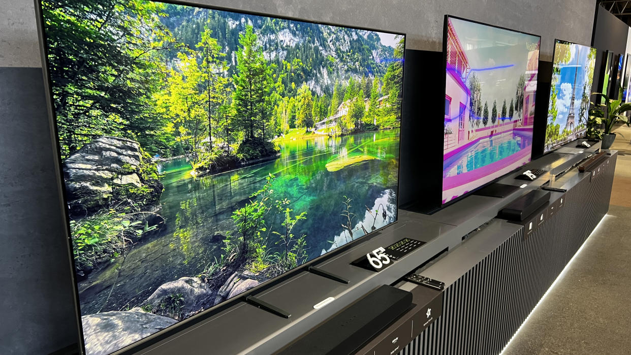  A range of Samsung TVs next to each other, in a long row. 