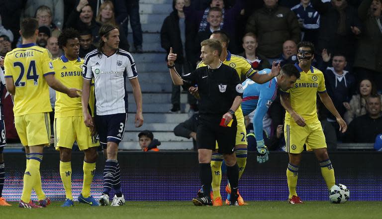 Referee Mike Jones (C) gestures towards West Bromwich Albion defender Jonas Olsson (3L) after showing a red card to Chelsea midfielder Cesc Fabregas (R) during the match on May 18, 2015