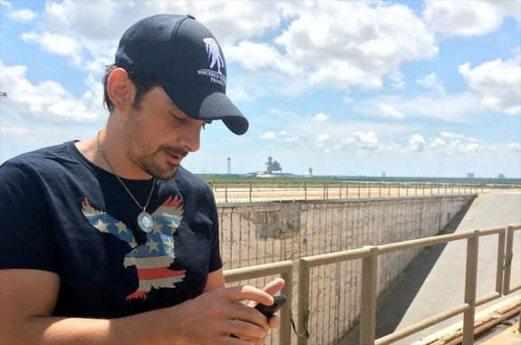 Country music star Brad Paisley uses his phone to 'leak' his new song, "American Flag on the Moon" from NASA's historic Launch Pad 39B at the Kennedy Space Center in Florida.