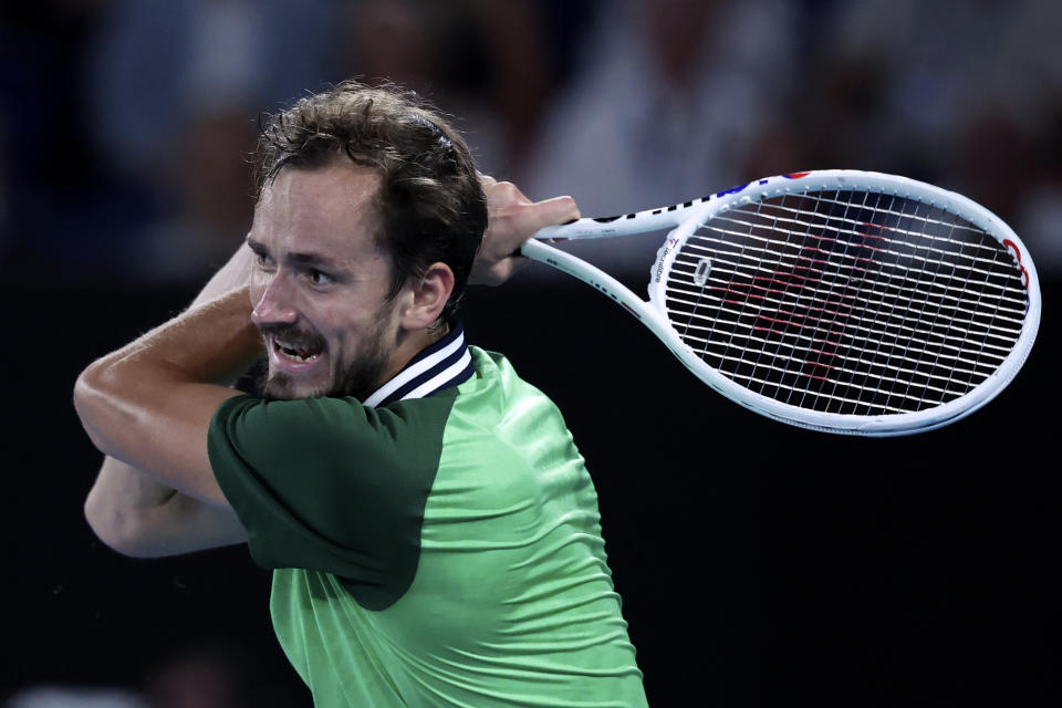 Daniil Medvedev of Russia plays a backhand return to Jannik Sinner of Italy during the men's singles final at the Australian Open tennis championships at Melbourne Park, in Melbourne, Australia, Sunday, Jan. 28, 2024. (AP Photo/Asanka Brendon Ratnayake)