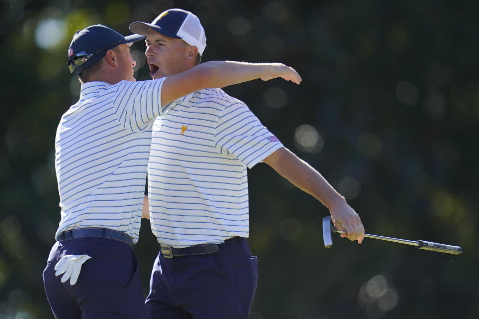 Jordan Spieth and Justin Thomas celebrate after winning the match during their fourball match at the Presidents Cup golf tournament at the Quail Hollow Club, Friday, Sept. 23, 2022, in Charlotte, N.C. (AP Photo/Julio Cortez)