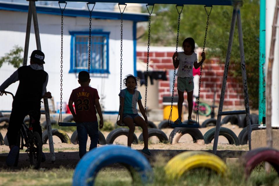Children play on a swingset at a migrant shelter in Anapra, just across the border from Sunland Park, on May 12.