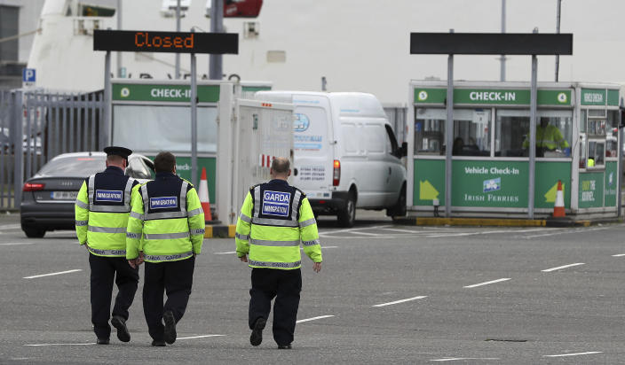 Garda immigration officers at Dublin Port, Ireland, Wednesday Oct. 23, 2019, that is reported to have been the likely exit point for a truck containing 39 people, to journey from Europe to the British ferry port at Holyhead in Wales. Murder investigators are trying to piece together the movements of a large cargo truck found in south-east England on Wednesday, containing the bodies of 39 people in one of Britain’s worst people smuggling tragedies. (Brian Lawless/PA via AP)