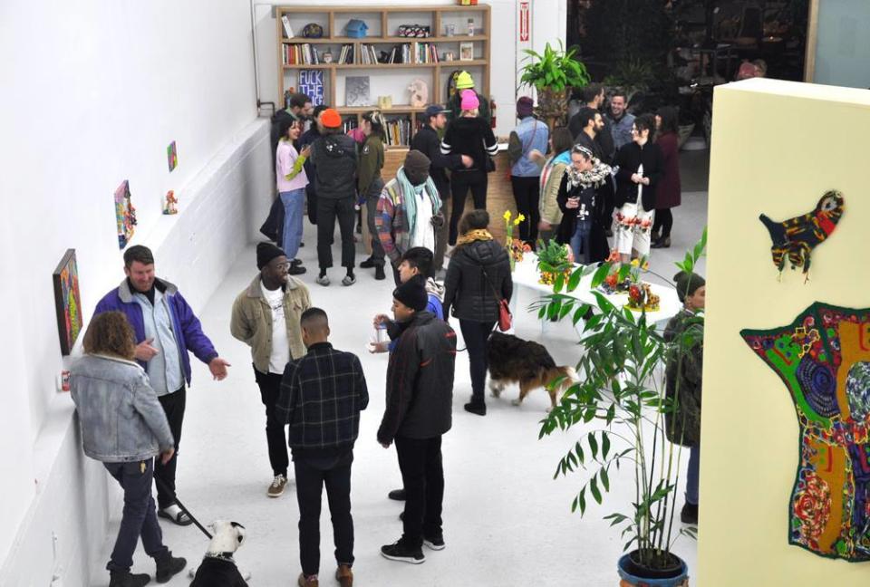 A crowd gathered in the gallery for a reception in January 2018