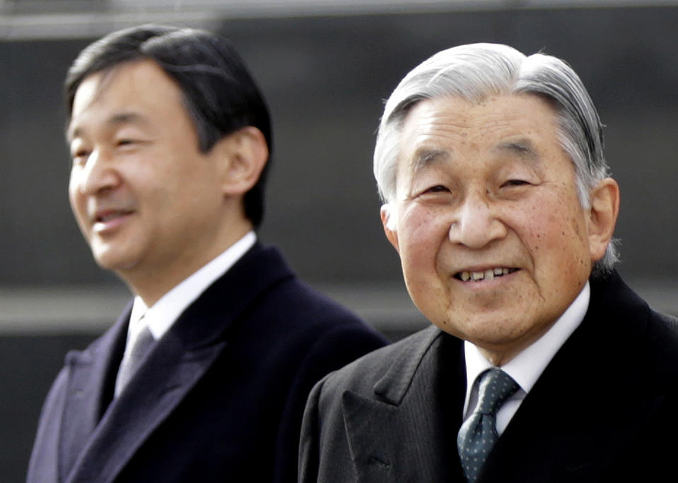 FILE - In this Jan. 26, 2016, file photo, Japan's Emperor Akihito, right, and Crown Prince Naruhito walk at Haneda international airport in Tokyo. Akihito has devoted his 30-year reign to making amends for a war fought in his father’s name, while adapting the 1,500-year-old monarchy to draw the Imperial Family closer to the public. Akihito’s Heisei era will end when he abdicates on April 30, 2019 in favor of his elder son, 58-year-old Naruhito, beginning a new, as yet unnamed era. (AP Photo/Eugene Hoshiko, File)