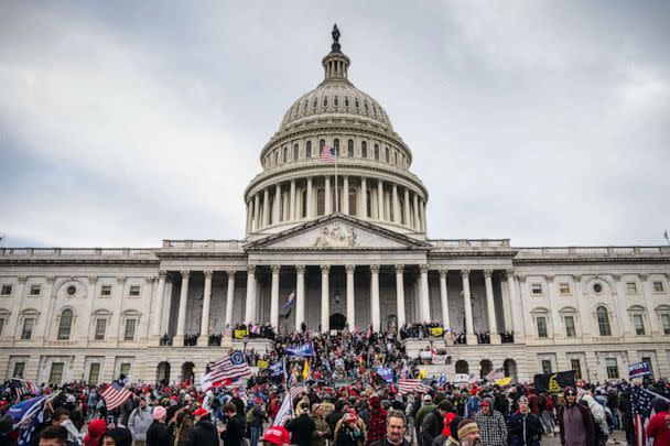 PHOTO: A large group of pro-Trump protesters stand on the East steps of the Capitol Building after storming its grounds, Jan. 6, 2021 in Washington, DC. (Jon Cherry/Getty Images)