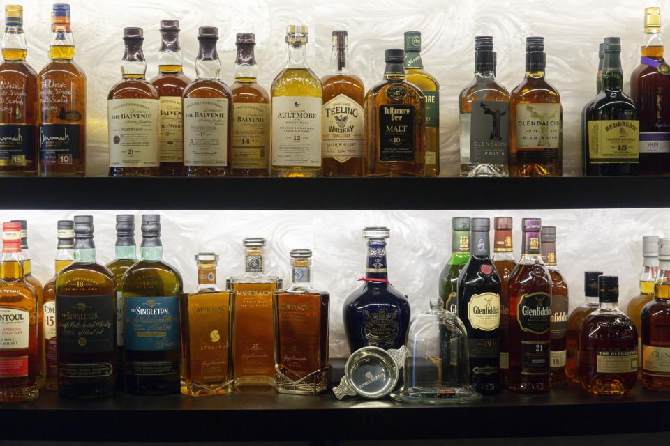 Bottles of whiskey sit on display behind the bar at the Door XXV private club in the Golden Equator Group office in Singapore, on Wednesday, Oct. 30, 2019.  (Ore Huiying/Bloomberg)