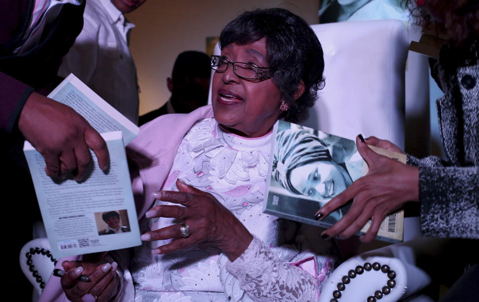 <p>Winnie Madikizela-Mandela, ex-wife of former South African President Nelson Mandela, is given copies to sign during a celebratory event for the release of her book, “491 Days,” on Aug. 8, 2013. (Photo: Siphiwe Sibeko/Reuters) </p>