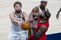 Houston Rockets center DeMarcus Cousins (15) and Indiana Pacers forward Domantas Sabonis (11) fight for a rebound during the third quarter of an NBA basketball game in Indianapolis, Wednesday, Jan. 6, 2021. (AP Photo/Michael Conroy)