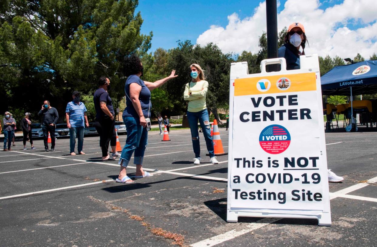 Voters queue at a safe social distance to cast their ballots in California's 25th congressional district: AFP via Getty Images