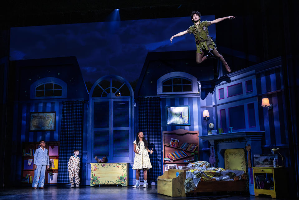 Peter Pan (Nolan Almeida) flies into the home of the Darlings, as John (Micah Turner Lee), Michael (Reed Epley) and Wendy (Hawa Kamara) watch. 