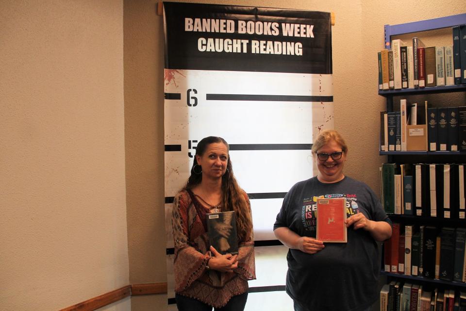 Alamogordo Public Library Youth Services Librarian Ami Jones holds up YA novel "SCARS" by Cheryl Rainfield and Adult Reference Librarian Jean-ann Stump holds up " The Curious Incident of the Dog in the Night-Time" by Mark Haddon. 

Alamogordo Public Library celebrated Banned Books Week in September 2022 with displays of books that have been banned or challenged across the country.