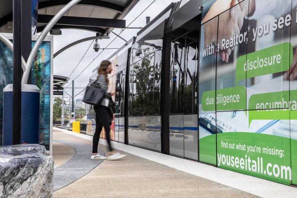 A woman boards the light rail on North Brevard Street in Charlotte, on Tuesday, August 17, 2021.