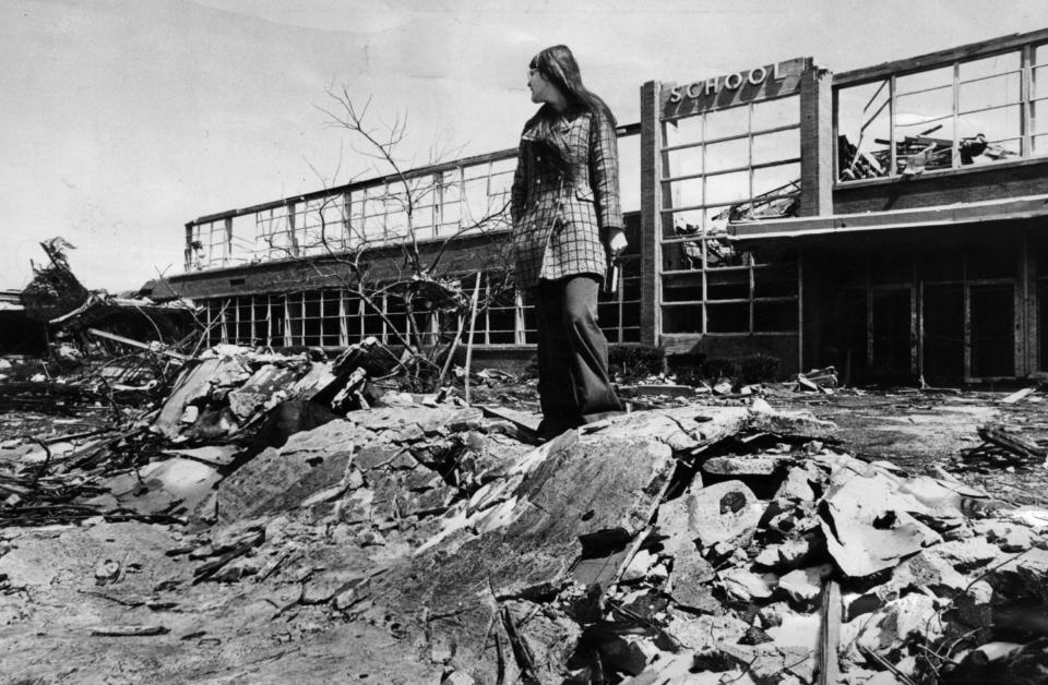 April 1974: Xenia High School senior Kim Karl surveys the remains of her school after the tornado's passing.