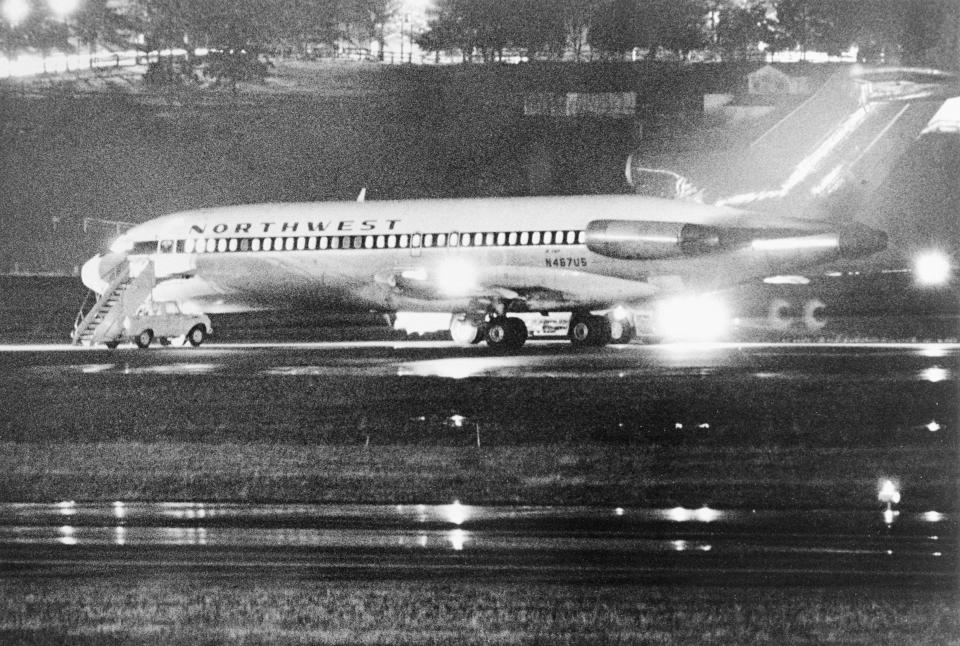 (Original Caption) Seattle: Northwest Airlines 727, hijacked on a flight from Portland, Oregon to Seattle, sits on the ground here 11/24. before being refueled and continuing on to Reno, Nevada. The hijacker received $200,000 here before allowing the 35 passengers and 2 stewardesses off the plane. He also demanded and received parachutes. When the plane landed in Reno, the hijacker was gone. This photo was made by Seattle Times photographer Bruce McKim with a 500 mm lens and a 4 minute exposure.