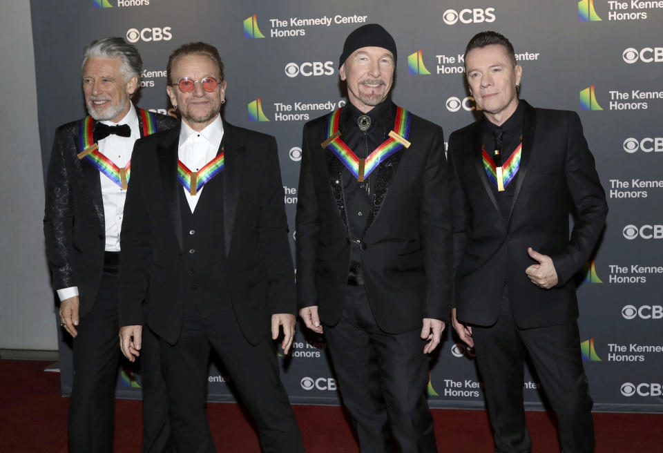 FILE - Adam Clayton, from left, Bono, The Edge and Larry Mullen Jr., of the Irish band U2, arrive at the Kennedy Center Honors in Washington on Dec. 4, 2022. The band's latest release, “Songs Of Surrender,” is a collection of 40 re-recorded and reimagined songs from across the band’s catalog. (Photo by Greg Allen/Invision/AP, File)