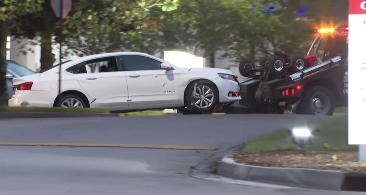 The shooter's car is towed away from the scene at Baptist Medical Center South where a Jacksonville Sheriff's Officer was shot in the face and the gunman killed on April 18.