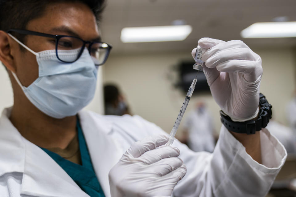 BETHESDA, MARYLAND - DECEMBER 14: HN Milan Torres prepares a dose of COVID-19 vaccine at the Walter Reed National Military Medical Center on December 14, 2020 in Bethesda, Maryland. Acting Secretary of Defense Christopher Miller received his first shot of the Pfizer-BioNTech COVID-19 vaccine, as the biggest vaccination campaign in U.S. history kicked off in an effort to get protection against the COVID-19 pandemic. (Photo by Manuel Balce Ceneta-Pool/Getty Images)