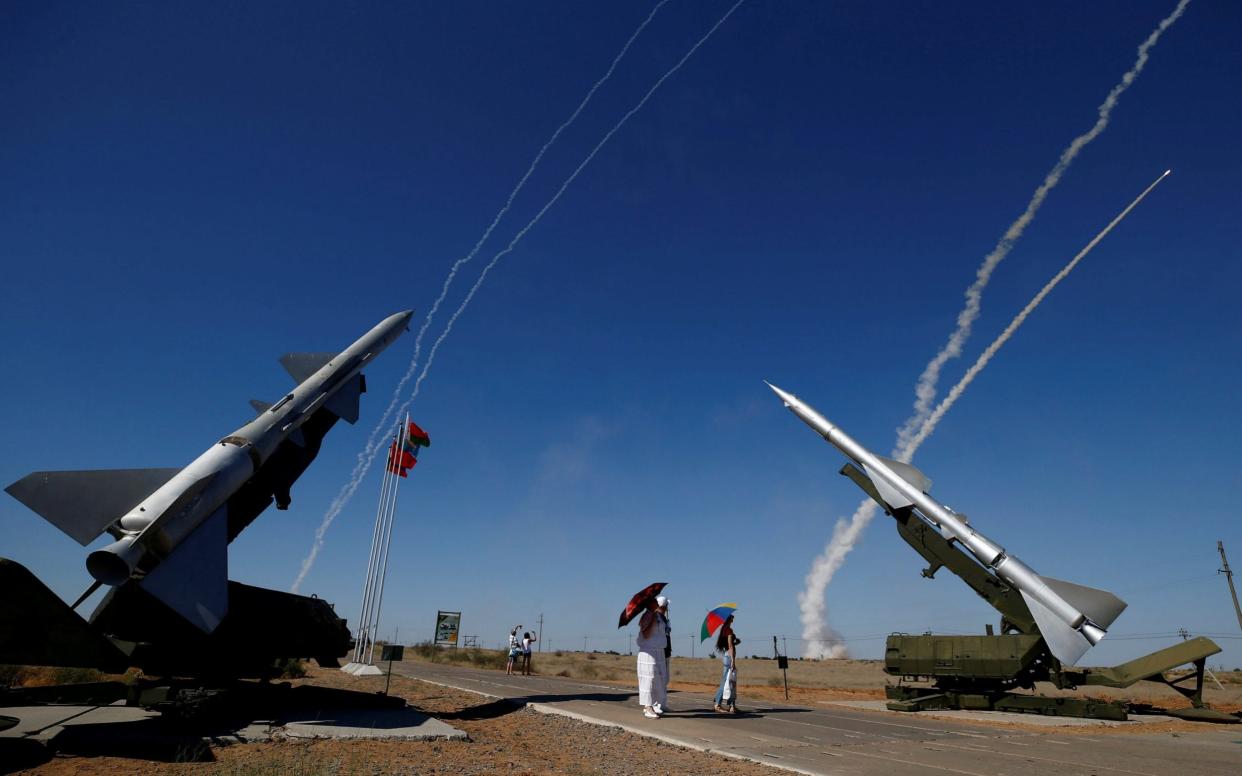 People watch S-300 air defense missile systems launching missiles - REUTERS
