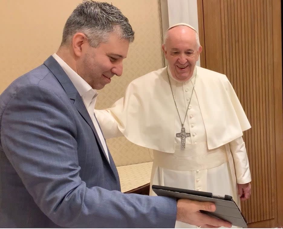 Evgeny Afineevsky showing Pope Francis footage from “Francesco” (Photo courtesy of Evgeny Afineevsky)