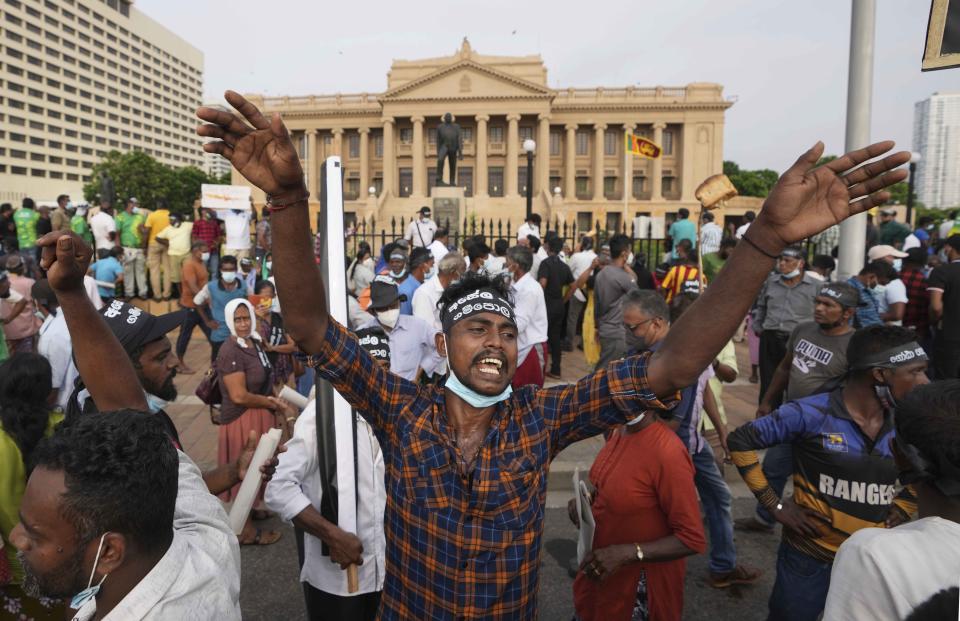 Supporters of Sri Lanka's main opposition shout slogans during a protest outside the president's office in Colombo, Sri Lanka, Tuesday, March 15, 2022. The protestors were demanding the resignation of President Gotabaya Rajapaksa as the country suffers one of the worst economic crises in history. (AP Photo/Eranga Jayawardena)