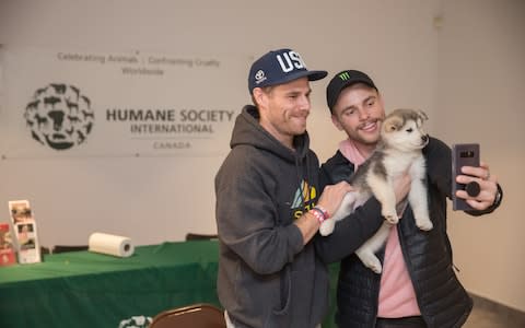 American Olympian Gus Kenworthy (right) and his boyfriend Matthew Wilkas (left) take a selfie after being reunited with their dog Beemo - Credit: Dario Ayala /  The Humane Society
