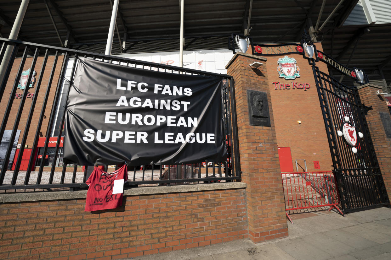 A banner is seen outside Liverpool's Anfield Stadium protesting the formation of the European Super League, Liverpool, England, Monday, April 19, 2021. Players at the 12 clubs setting up their own Super League could be banned from this year's European Championship and next year's World Cup, UEFA President Aleksander Ceferin said Monday. (AP Photo/Jon Super)