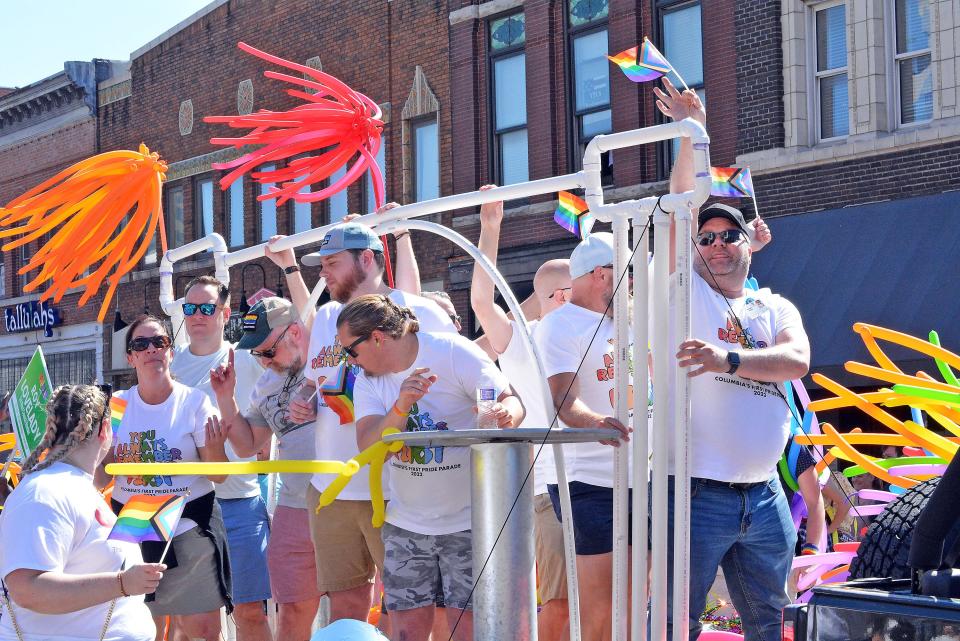 Patrons and employees of Columbia LGBTQ bar Arch and Column ride the business' float Sept. 25, 2022 as part of the inaugural Mid-MO PrideFest parade in downtown Columbia.