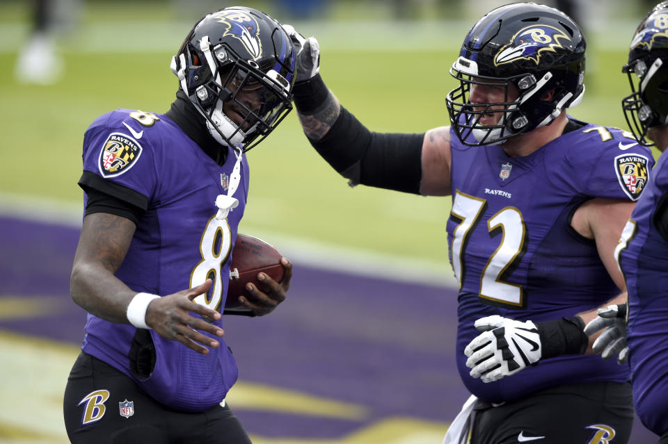 Baltimore Ravens quarterback Lamar Jackson (8) is congratulated by guard Ben Powers (72) after scoring a touchdown on a run against the Jacksonville Jaguars during the second half of an NFL football game, Sunday, Dec. 20, 2020, in Baltimore. (AP Photo/Gail Burton)