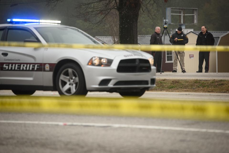 Law enforcement officers investigate the death of a Cumberland County Sheriff's Office Deputy, who was struck by a vehicle on Gillespie Street at Dedication Drive early Friday. 