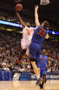 PHOENIX, AZ - MARCH 24: Chris Smith #5 of the Louisville Cardinals goes up for a shot over Erik Murphy #33 of the Florida Gators in the second half during the 2012 NCAA Men's Basketball West Regional Final at US Airways Center on March 24, 2012 in Phoenix, Arizona. (Photo by Christian Petersen/Getty Images)