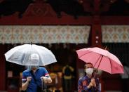 Visitors wearing protective face masks are seen at a shrine amid the coronavirus disease (COVID-19) outbreak, in Tokyo