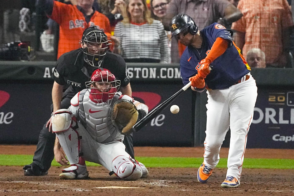 Houston Astros' Christian Vazquez hits an RBI single during the sixth inning in Game 6 of baseball's World Series between the Houston Astros and the Philadelphia Phillies on Saturday, Nov. 5, 2022, in Houston. (AP Photo/Sue Ogrocki)