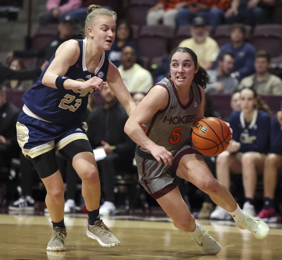 Virginia Tech's Georgia Amoore (5) drives past Georgia Tech's Rusne Augustinaite (23) in the first half of an NCAA college basketball game Thursday, Jan. 25, 2024, in Blacksburg, Va. (Matt Gentry/The Roanoke Times via AP)