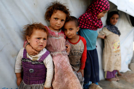 Children stand next to a tent at a camp for people displaced by the war near Sanaa, Yemen April 24, 2017. REUTERS/Khaled Abdullah