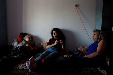 Romania-Roma actress Mihaela Dragan (C), lays on a couch with her mother (R) and grandmother (L), during a family visit in Constanta, Romania, December 7, 2017. REUTERS/Andreea Campeanu