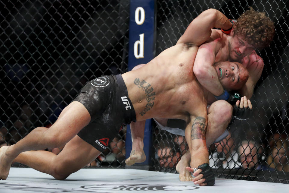 Ben Askren chokes Robbie Lawler in a welterweight mixed martial arts bout at UFC 235, Saturday, March 2, 2019, in Las Vegas. (AP Photo/John Locher)