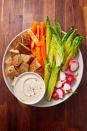 <p>Give your crowd something to snack on while leaving room for the main spread.</p><p>Get the recipe from <a href="https://www.delish.com/cooking/recipe-ideas/a29540357/veggie-dip-recipe/" rel="nofollow noopener" target="_blank" data-ylk="slk:Delish;elm:context_link;itc:0;sec:content-canvas" class="link ">Delish</a>. </p>