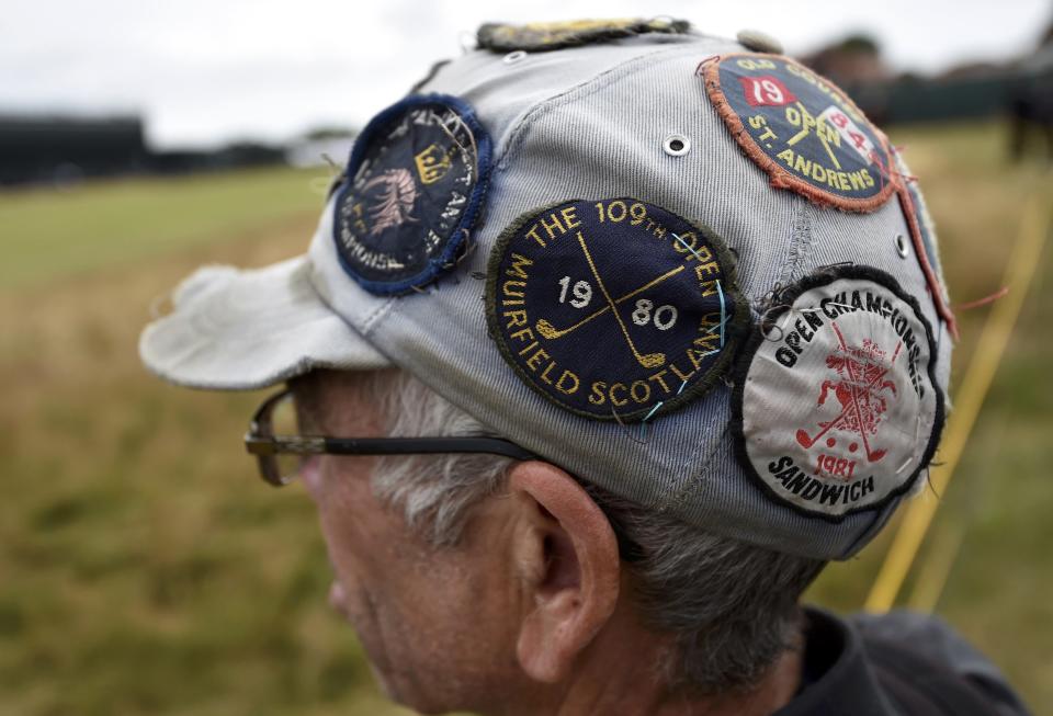 A spectator wearing a hat with golf badges watches play during a practice round ahead of the British Open Championship at the Royal Liverpool Golf Club in Hoylake, northern England July 16, 2014. REUTERS/Toby Melville (BRITAIN - Tags: SPORT GOLF)