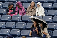 Tennis fans wait out a rain delay during the second round of the US Open tennis championships, Wednesday, Sept. 1, 2021, in New York. (AP Photo/Elise Amendola)