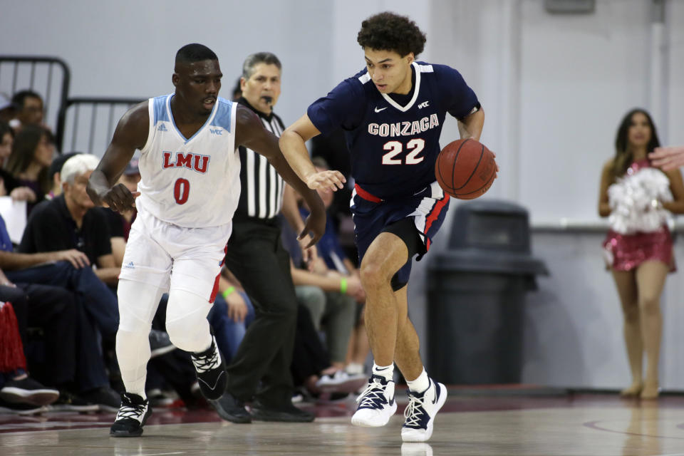 Gonzaga forward Anton Watson (22) drives past Loyola Marymount guard Eli Scott (0) during the first half of an NCAA college basketball game in Los Angeles, Saturday, Jan. 11, 2020. (AP Photo/Alex Gallardo)