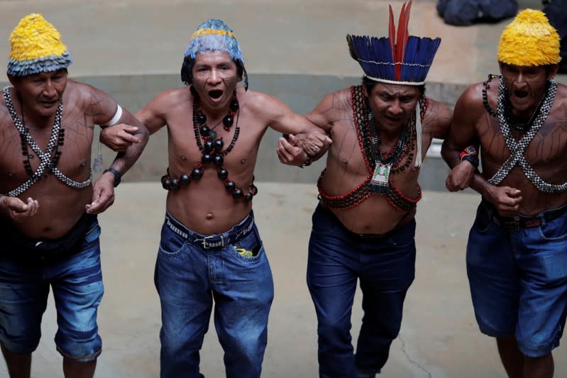 Indigenous people of the Munduruku tribe dance during a press conference to ask authorities for protection for indigenous land and cultural rights in Brasilia