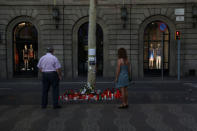 People stand at an impromptu memorial where a van crashed into pedestrians at Las Ramblas in Barcelona, Spain August 21, 2017. REUTERS/Susana Vera