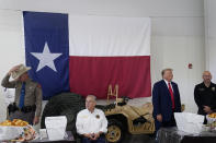 Republican presidential candidate and former President Donald Trump and Texas Gov. Greg Abbott help serve food to Texas National Guard soldiers, troopers and others who will be stationed at the border over Thanksgiving, Sunday, Nov. 19, 2023, in Edinburg, Texas. (AP Photo/Eric Gay)