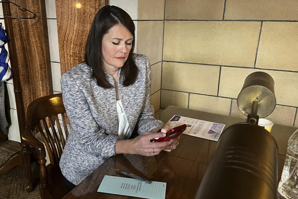 Omaha Sen. Kathleen Kauth works inside the Nebraska legislative chamber on Thursday, March 23, 2023 as her bill, which would ban gender-affirming care for anyone 18 and younger in the state, was debated. The contentious bill advanced Thursday, despite a threat by several lawmakers to filibuster the rest of the session if it moved forward. (AP Photo/Margery Beck)