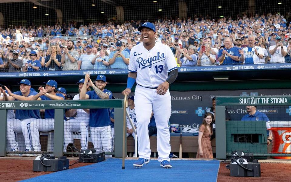 Kansas City Royals’ Salvador Perez laughs as he brings a cane to former Kansas City Royals center fielder Lorenzo Cain during a retirement ceremony at Kauffman Stadium on Saturday, May 6, 2023, in Kansas City. Cain signed a ceremonial one-day contract to retire as a Royal.
