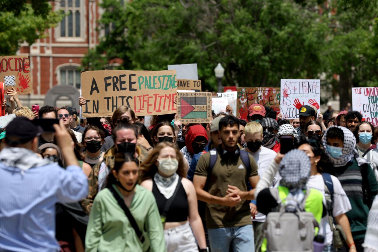 People hold signs in support of Palestine during a May Day rally on Wednesday on the University of Oklahoma Norman campus. The rally was hosted by the Student Coalition for Palestinian Liberation and Student Socialist League.